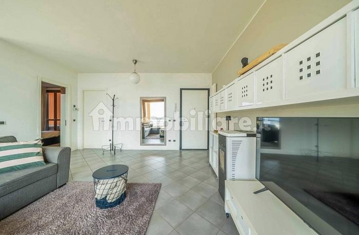 Großzügiger Wohn-/Essbereich mit Panoramafenster, Pelletofen, SAT-TV und direktem Zugang zum großen, möblierten 20 m² Balkon mit spektakulärem Seeblick